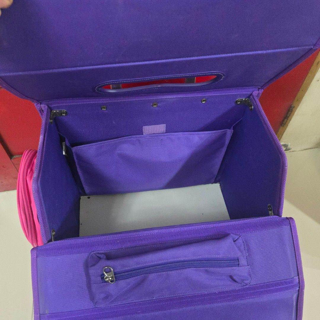Purple and Pink Rolling Backpack with Telescopic Handle (Category: Backpacks) located in Las Pinas. Submitted by destashingpinayph (Listing ID 1456826508, Image 2). Description: RFS : decluttering - Adorable rolling backpack for kids - Vibrant purple and pink design - Easy-to-use telescopic handle - Multiple compartments for organization - Smooth-working zippers - Functional wheels for effortless pulling - Ideal for school, day trips, or travel a