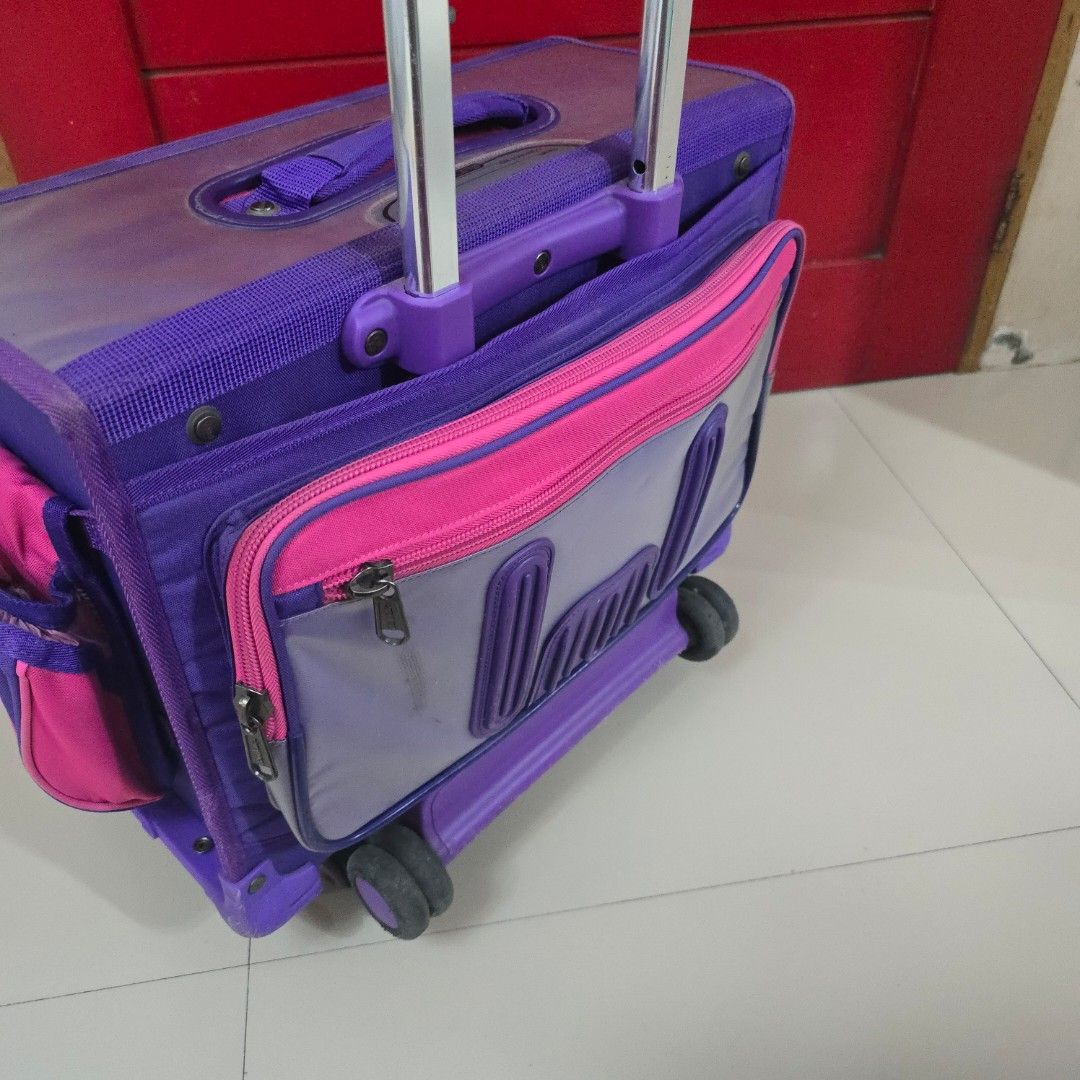 Purple and Pink Rolling Backpack with Telescopic Handle (Category: Backpacks) located in Las Pinas. Submitted by destashingpinayph (Listing ID 1456826508, Image 3). Description: RFS : decluttering - Adorable rolling backpack for kids - Vibrant purple and pink design - Easy-to-use telescopic handle - Multiple compartments for organization - Smooth-working zippers - Functional wheels for effortless pulling - Ideal for school, day trips, or travel a