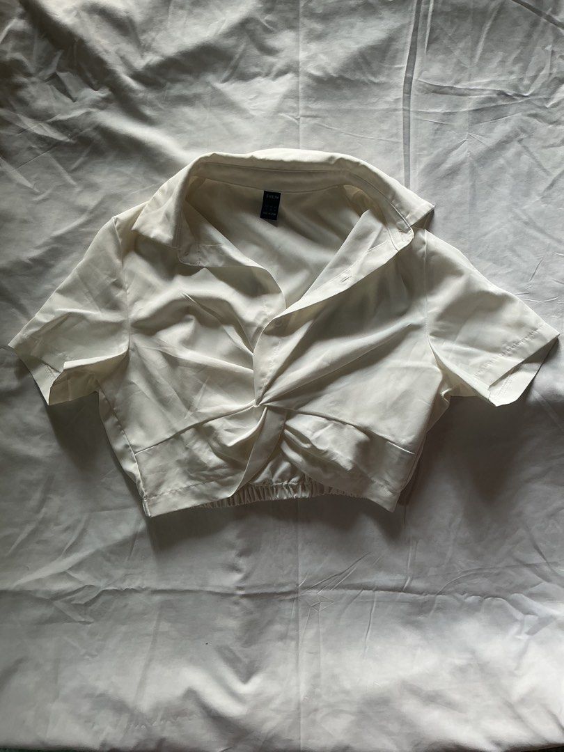 SHEIN White Twist Front Cropped Shirt (Category: Blouses) located in Candon. Submitted by czaeya (Listing ID 1456791056, Image 1). Description: ♡ never been used, was stored for a long time ♡ rfs: should have bought xs instead ♡ loc: candon, ilocos sur ♡ payment first policy! <33 ♡ send a message if interested :) mod: jnt (sf is buyer’s expense) mop: gcash or bank transfer (maribank).