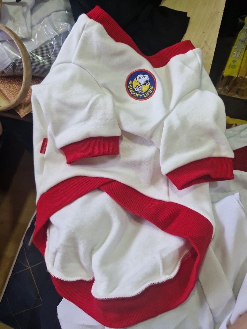 Snoopy White & Red Dog Shirt (Category: Homes & Other Pet Accessories) located in Manila. Submitted by inaydearest (Listing ID 1456823237, Image 2). Description: - Adorable Snoopy shirt for your pet - Classic white with stylish red trim and cuffs - Features a cute Snoopy logo patch on the chest - Made from a comfortable cotton blend - Perfect for keeping your pet cozy and fashionable - Easy to put on and take off.