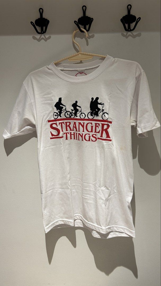 Stranger Things T-shirt White Seashop (Category: Tshirts & Polo Shirts ) located in Manila. Submitted by emiluh (Listing ID 1456918912, Image 1). Description: - White Stranger Things t-shirt - Size: Medium, relaxed fit - Small stain on the front right side (as pictured) - loose threads around neckline area - Great for Stranger Things fans!.