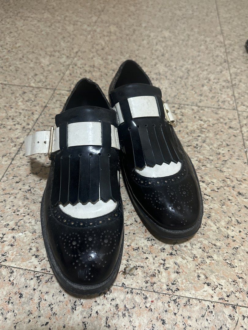 TOD'S Black & White Wingtip Brogues with Fringe (Category: Flats & Sandals) located in Manila. Submitted by martinezabby (Listing ID 1456788251, Image 1). Description: - Brand: TOD'S - Style: Wingtip Brogues - Color: Black and White - Size: 35-36 - Details: Fringe across vamp, buckle strap, classic brogue perforations - Sole: Rubber with TOD'S branding - Versatility: Perfect for dressing up or down.