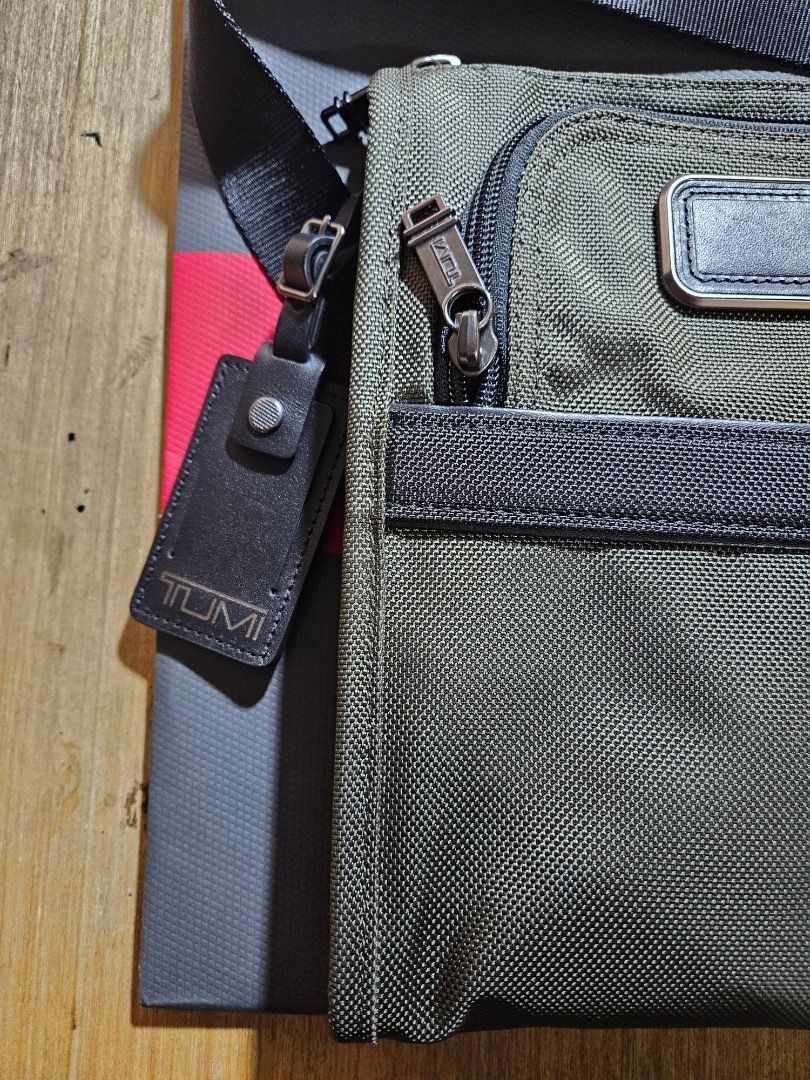Tumi Olive Green Alpha Pocket Sling (Category: Luxury Bags & Wallets) located in Valenzuela. Submitted by _myperfectstuff (Listing ID 1456855574, Image 2). Description: - Tumi crossbody bag in stylish olive green. - Crafted from durable nylon with premium leather trim. - Features a spacious main zippered compartment. - Includes a convenient front zippered pocket. - Adjustable shoulder strap for personalized comfort. - Comes with an authentic Tumi