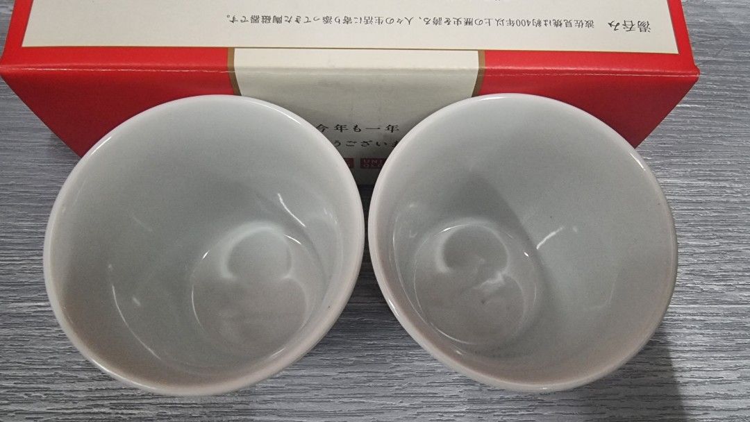 Uniqlo Ceramic Cups Set of 2 (Category: Coffee & Tea Tableware) located in Manila. Submitted by themvi (Listing ID 1456851236, Image 2). Description: - Set of 2 Uniqlo ceramic cups - Classic white with iconic red square logo - Includes original red gift box with Japanese text - Ideal for enjoying your favorite tea or coffee - Makes a thoughtful gift idea.