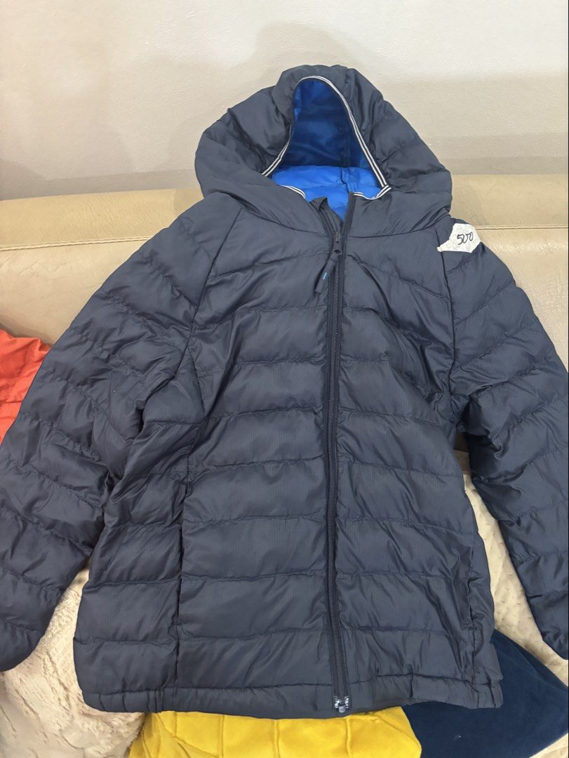 Uniqlo Kids Puffer Jacket Size 120 (Category: Babies & Kids Fashion) located in Lipa City. Submitted by madmaxxene (Listing ID 1441661641, Image 1). Description: - Uniqlo Puffer Jacket for Kids - Color: Navy Blue (also avail in orange) - Size: 120 - Lightweight and warm, ideal for cooler weather - Features a hood - Easy to zip up - Great for everyday wear.