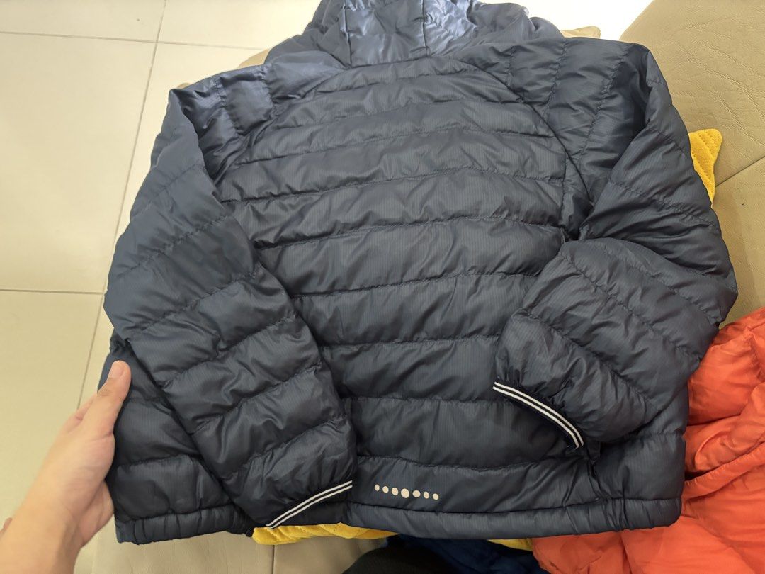Uniqlo Kids Puffer Jacket Size 120 (Category: Babies & Kids Fashion) located in Lipa City. Submitted by madmaxxene (Listing ID 1441661641, Image 3). Description: - Uniqlo Puffer Jacket for Kids - Color: Navy Blue (also avail in orange) - Size: 120 - Lightweight and warm, ideal for cooler weather - Features a hood - Easy to zip up - Great for everyday wear.