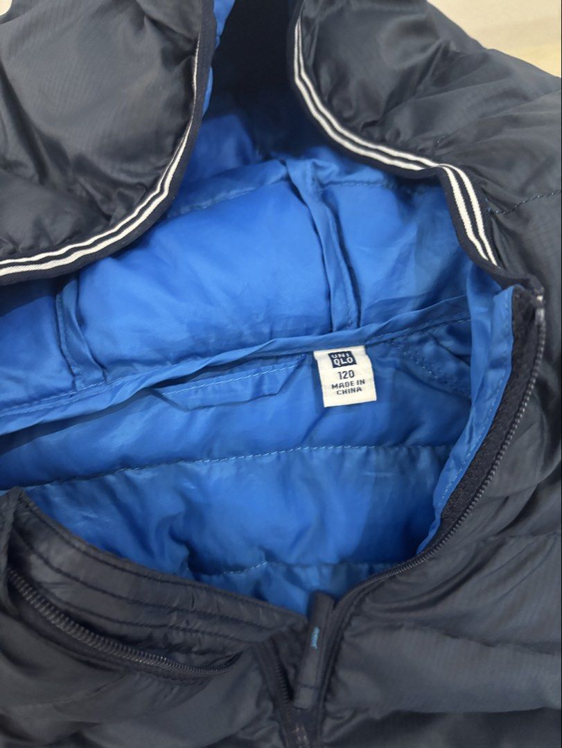 Uniqlo Kids Puffer Jacket Size 120 (Category: Babies & Kids Fashion) located in Lipa City. Submitted by madmaxxene (Listing ID 1441661641, Image 2). Description: - Uniqlo Puffer Jacket for Kids - Color: Navy Blue (also avail in orange) - Size: 120 - Lightweight and warm, ideal for cooler weather - Features a hood - Easy to zip up - Great for everyday wear.