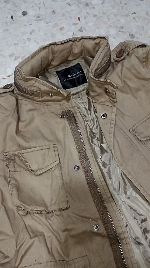 Utility Jacket (Category: Coats, Jackets and Outerwear) located in Puchong. Submitted by farr0s (Listing ID 1456930127, Image 2). Description: - Khaki utility jacket with multiple pockets - Zip and button closure - Drawstring waist for adjustable fit - Collar can be buttoned up - Ideal for layering/ hiking -Size: m -Top: 38" bust , length 21" -Condition: 8/10, no defect.