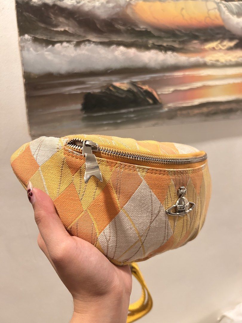 Vivienne westwood Argyle Belt Bag (Category: Luxury Bags & Wallets) located in Pasig City. Submitted by kawaiibags (Listing ID 1456832014, Image 3). Description: - Vivienne Westwood - Argyle Belt Bag - Yellow and white/cream tones. - Adjustable strap, zippered closure, compact size for essentials. - Can be worn as a belt bag or crossbody. Issue: need wash only.