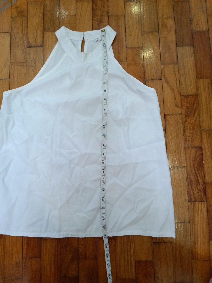 White Halter Neck Top (Category: Sleeveless) located in Quezon City. Submitted by cheecharon (Listing ID 1456785602, Image 3). Description: - Classic white halter neck top - Features a stylish gathered detail at the neckline - Convenient button closure at the back of the neck - A versatile and simple piece for any occasion. Great for casual or semi formal wear - Slight stains at the underarms and neck, but not noticeable when worn .