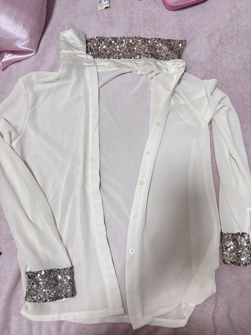 White Sheer Shirt with Sequin Cuffs and Collar (Category: Blouses) located in Pasig City. Submitted by cleaning.closet (Listing ID 1456855114, Image 1). Description: Sheer white long-sleeved shirt. sparkly sequin details on the cuffs and collar. Button-up front. Lightweight and flowy material. Great for layering or dressing up an outfit. Looks good with jeans or dress pants..