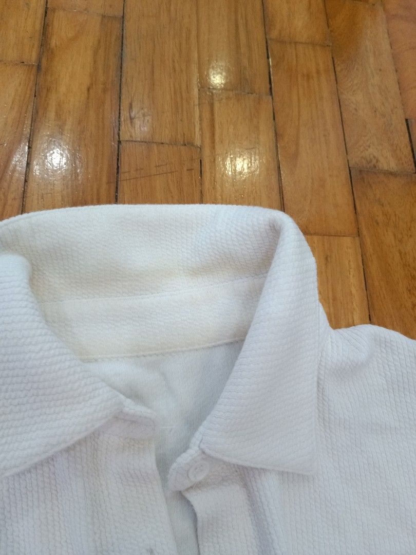 White Textured Short Sleeve Button-Up Shirt (Category: Tshirts & Polo Shirts ) located in Quezon City. Submitted by cheecharon (Listing ID 1456786964, Image 2). Description: - White textured shirt with thick and stretchy fabric - Has slight stain on the collar but not noticeable when worn - Great for casual or office wear.