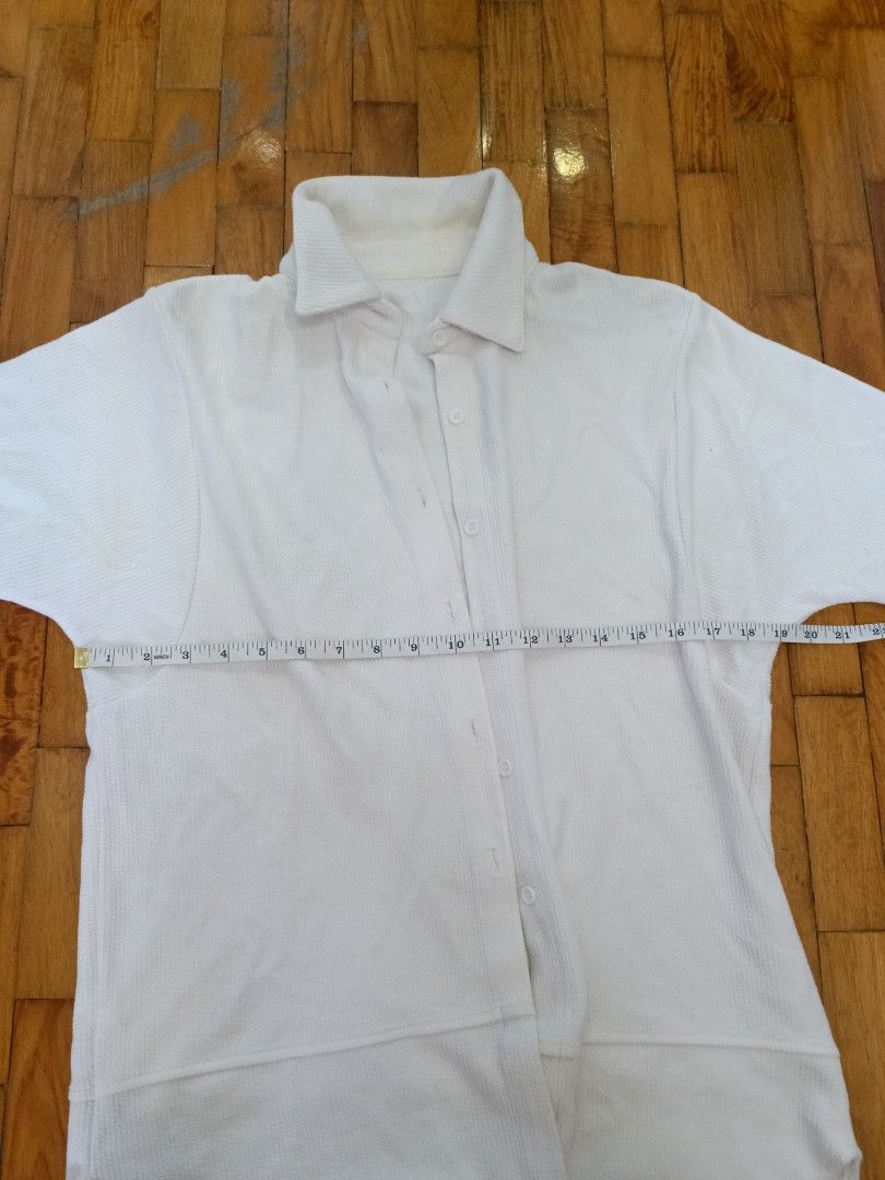 White Textured Short Sleeve Button-Up Shirt (Category: Tshirts & Polo Shirts ) located in Quezon City. Submitted by cheecharon (Listing ID 1456786964, Image 3). Description: - White textured shirt with thick and stretchy fabric - Has slight stain on the collar but not noticeable when worn - Great for casual or office wear.