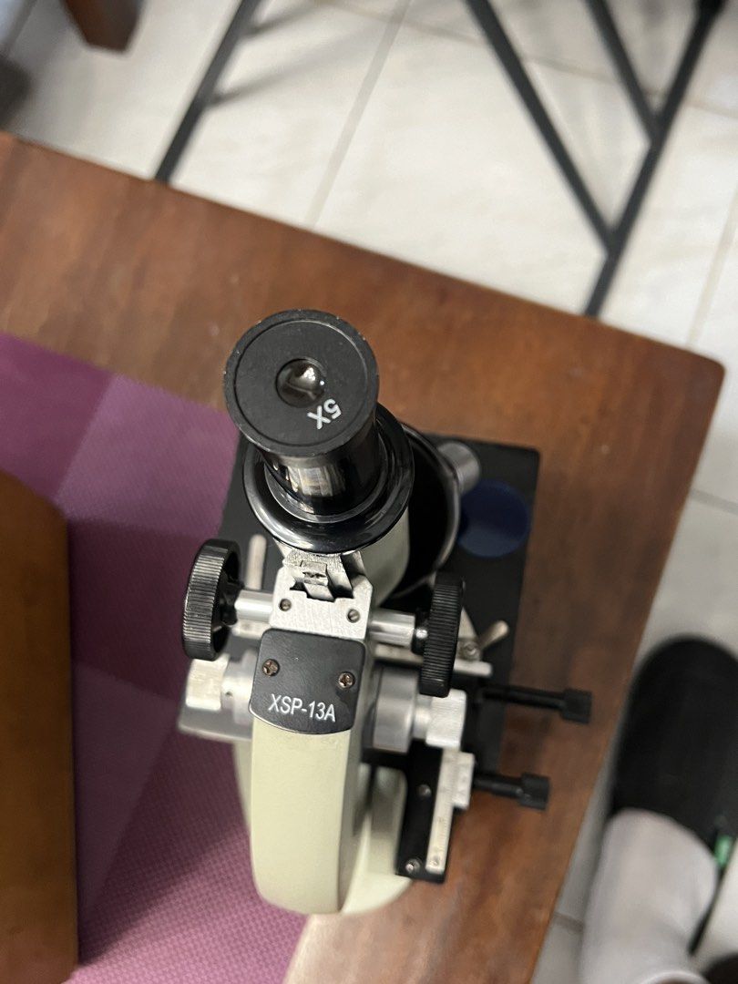 XSP-13A Microscope with Wooden Case + eye piece micrometer (Category: Medical Supplies & Tools) located in Cainta. Submitted by deeppockets696969 (Listing ID 1456950837, Image 3). Description: - Microscope Model: XSP-13A - Eyepiece: X5 magnification - Includes: Sturdy wooden case - Stage: Features measurement markings for precision - Focus Knobs: Operates smoothly for easy adjustments - Condition: Ready for your next observation XSP-13A 5x standa
