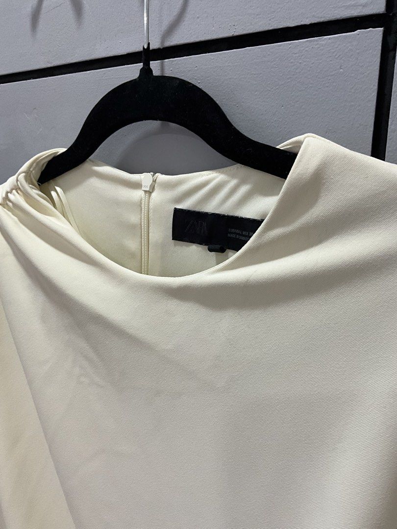 ZARA Ruched Midi Dress Cream (Category: Dresses) located in Manila. Submitted by shopmrld (Listing ID 1456936073, Image 3). Description: - ZARA cream midi dress - Size on tag : L - Runs small - Flattering ruched side detail - Zipper closure at the back - Used once only.