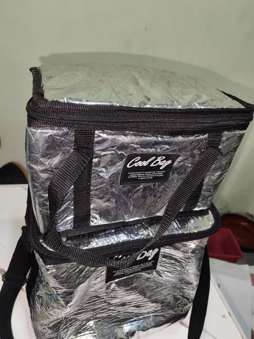 2pcs Silver Insulated Cooler Bag Set (Category: Breastfeeding & Bottle Feeding) located in Manila. Submitted by reascheyss51406 (Listing ID 1457024180, Image 2). Description: - Set of two silver insulated cooler bags - Keeps food and drinks cold - Secure zip closure - Features handles and a shoulder strap - Perfect for picnics, beach trips, or grocery runs - Easy to clean interior.
