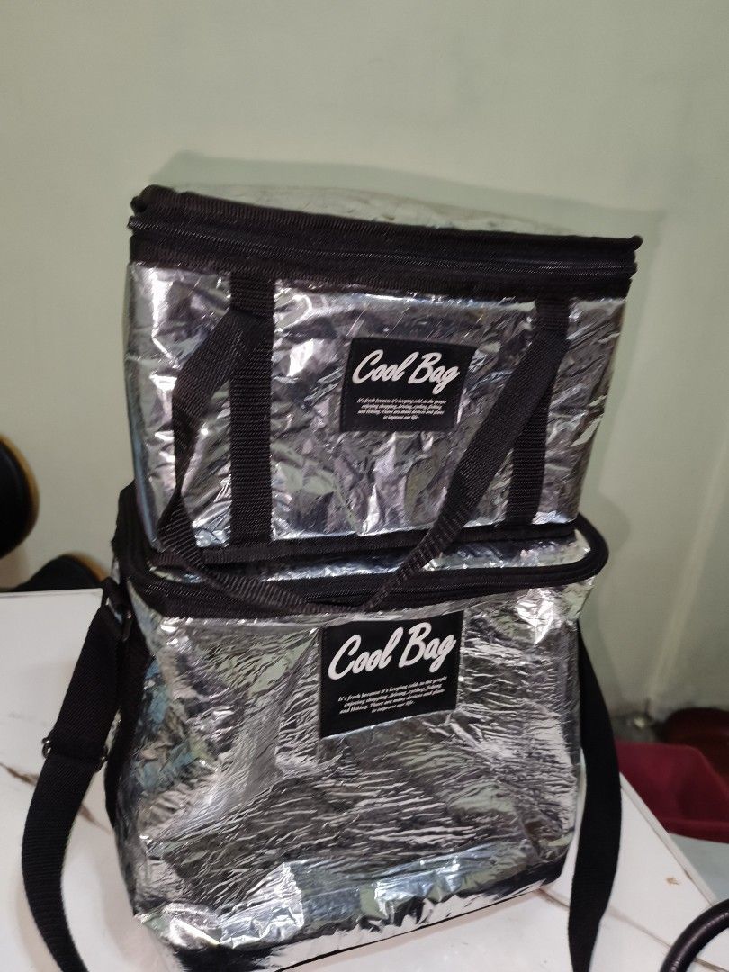 2pcs Silver Insulated Cooler Bag Set (Category: Breastfeeding & Bottle Feeding) located in Manila. Submitted by reascheyss51406 (Listing ID 1457024180, Image 1). Description: - Set of two silver insulated cooler bags - Keeps food and drinks cold - Secure zip closure - Features handles and a shoulder strap - Perfect for picnics, beach trips, or grocery runs - Easy to clean interior.