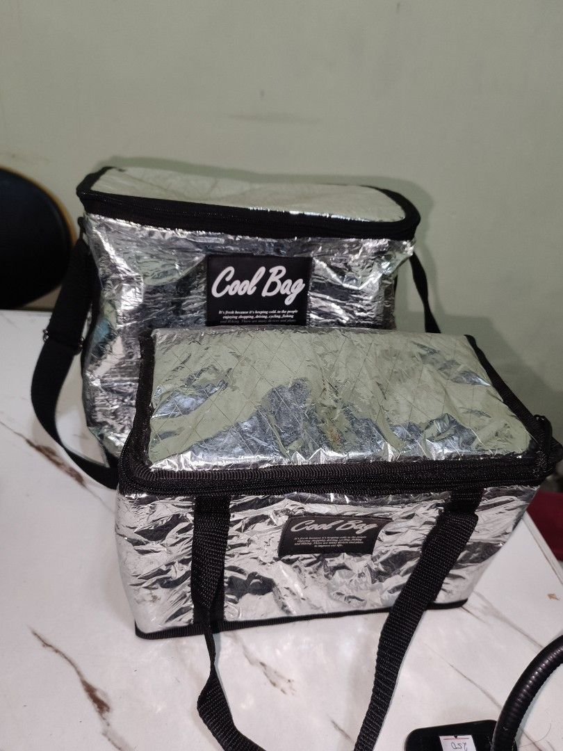 2pcs Silver Insulated Cooler Bag Set (Category: Breastfeeding & Bottle Feeding) located in Manila. Submitted by reascheyss51406 (Listing ID 1457024180, Image 3). Description: - Set of two silver insulated cooler bags - Keeps food and drinks cold - Secure zip closure - Features handles and a shoulder strap - Perfect for picnics, beach trips, or grocery runs - Easy to clean interior.