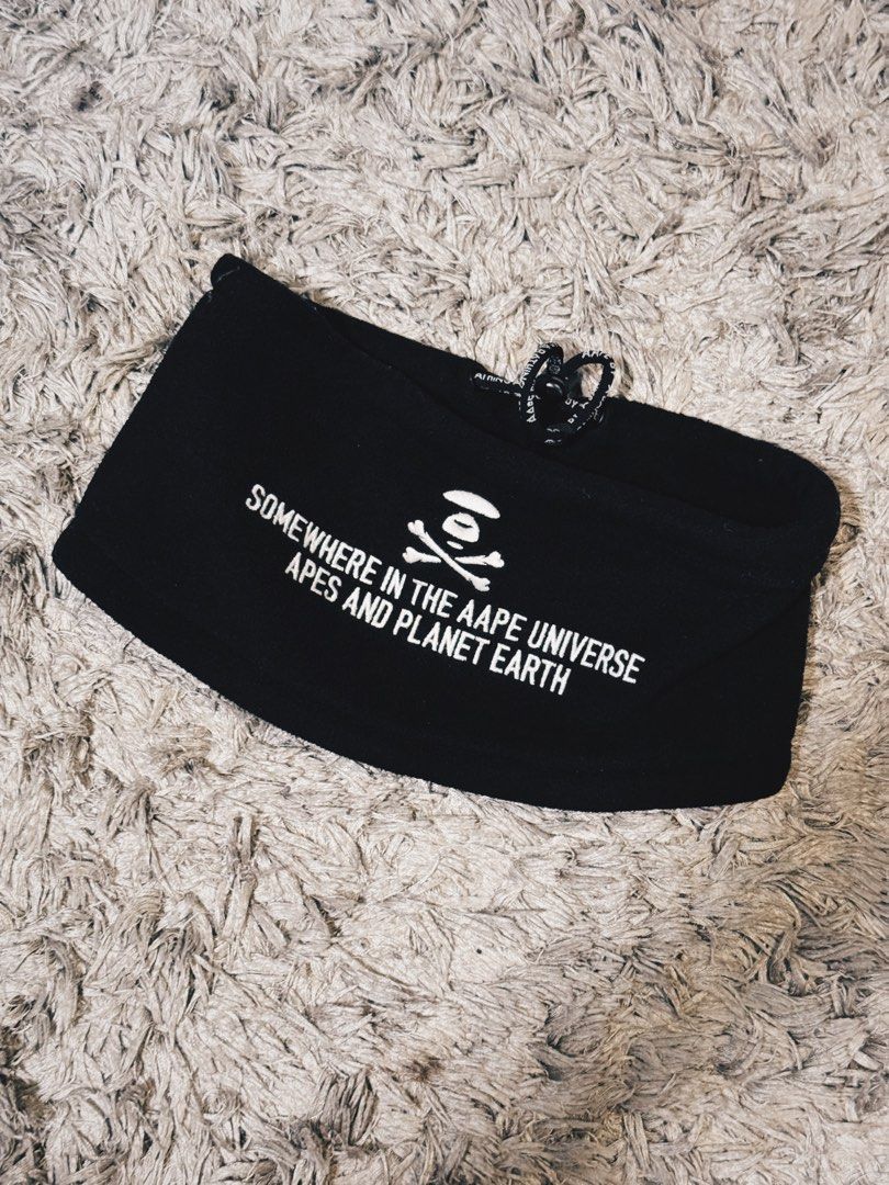 AAPE BY A BATHING APE neck warmer (Category: Luxury Accessories) located in Caloocan City. Submitted by onetwelvetwelve (Listing ID 1456995202, Image 2). Description: - Brand: AAPE BY A BATHING APE - Color: Black - Design: Features classic ape logo and "SOMEWHERE IN THE AAPE UNIVERSE APES AND PLANET EARTH" text - Material: Soft, fleece-like fabric - Uses: Ideal for keeping ears warm or for athletic activities - Sizing: One size fits most.