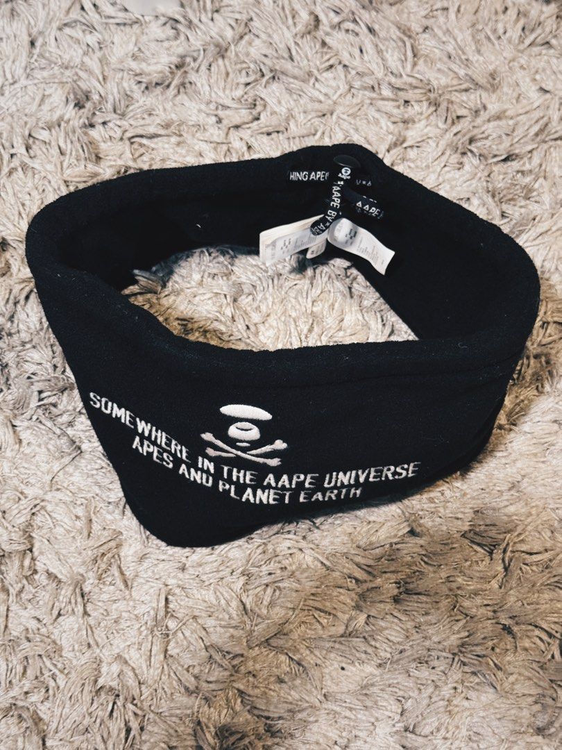 AAPE BY A BATHING APE neck warmer (Category: Luxury Accessories) located in Caloocan City. Submitted by onetwelvetwelve (Listing ID 1456995202, Image 1). Description: - Brand: AAPE BY A BATHING APE - Color: Black - Design: Features classic ape logo and "SOMEWHERE IN THE AAPE UNIVERSE APES AND PLANET EARTH" text - Material: Soft, fleece-like fabric - Uses: Ideal for keeping ears warm or for athletic activities - Sizing: One size fits most.