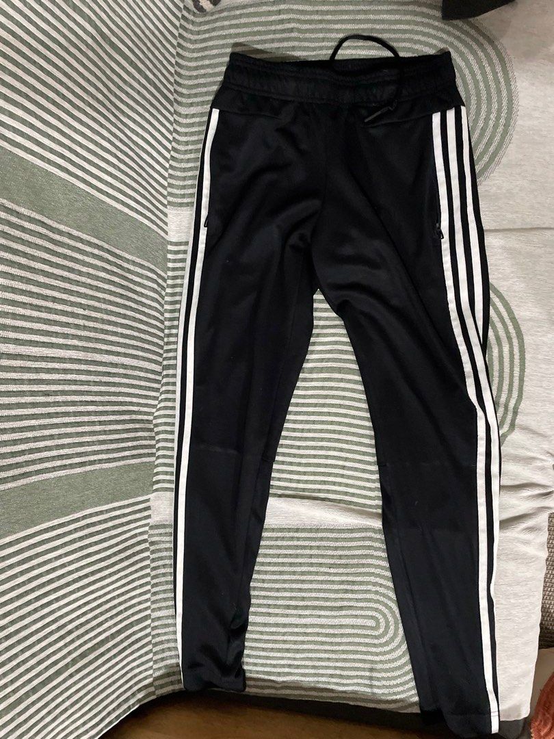 Adidas Black Track Pants with White Stripes (Category: Activewear) located in Dumaguete. Submitted by han_heuinanta (Listing ID 1457034810, Image 1). Description: - Black Adidas track pants - Size XS - Classic white three stripes down the sides - Drawstring waist for adjustable fit - Zippered pockets for secure storage - Made in Indonesia Negotiable.