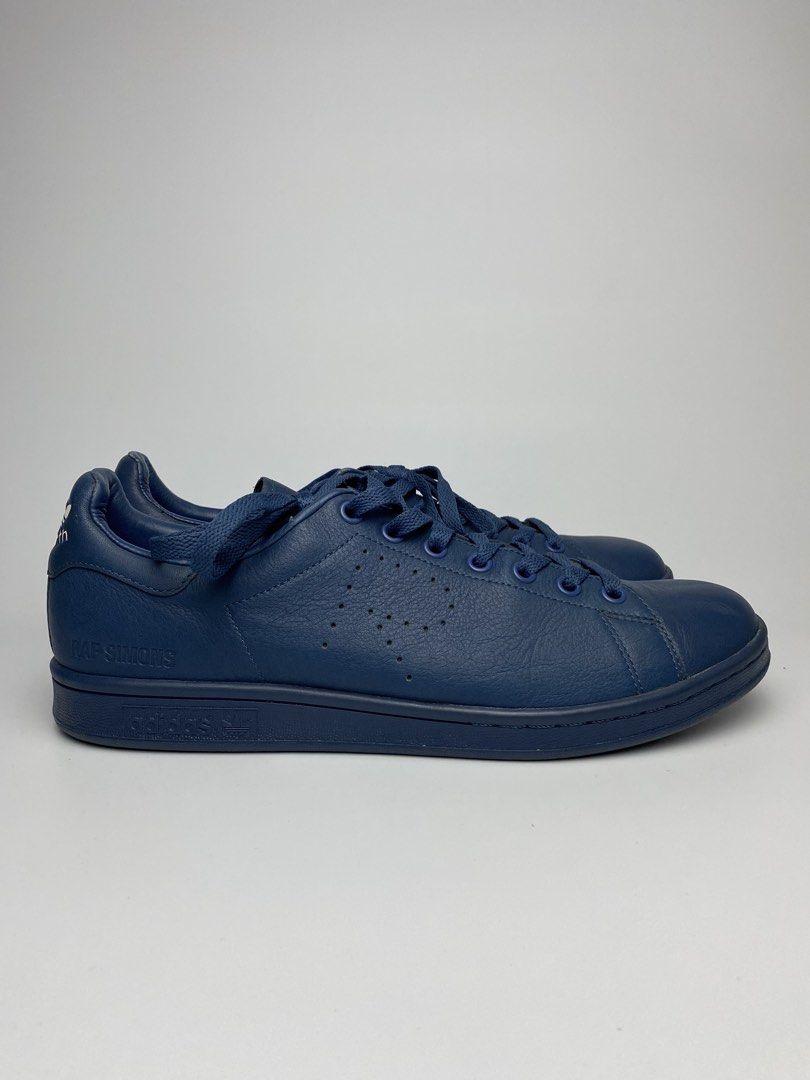 Adidas Raf Simons Stan Smith Navy Blue Leather Sneakers (Category: Sneakers) located in Lipa City. Submitted by 4217_ (Listing ID 1457010677, Image 2). Description: - Navy blue Adidas Stan Smith sneakers designed by Raf Simons - Premium leather construction - Classic silhouette with Raf Simons branding - Perforated Adidas logo detail - Lace-up closure - Ideal for casual wear.