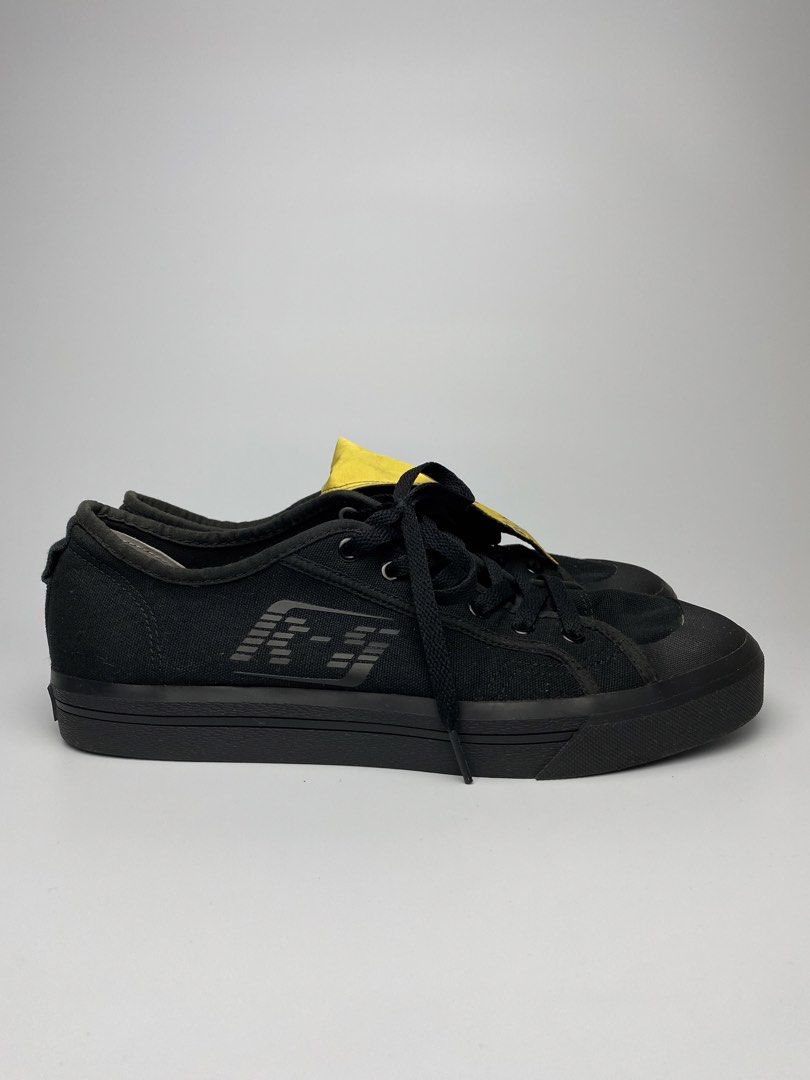Adidas x raf simons (Category: Sneakers) located in Lipa City. Submitted by 4217_ (Listing ID 1457010336, Image 2). Description: - Black canvas low-top sneakers - Subtle logo detail on the side - Secure lace-up closure - Durable rubber sole - Yellow tag inside - Ideal for casual everyday wear.