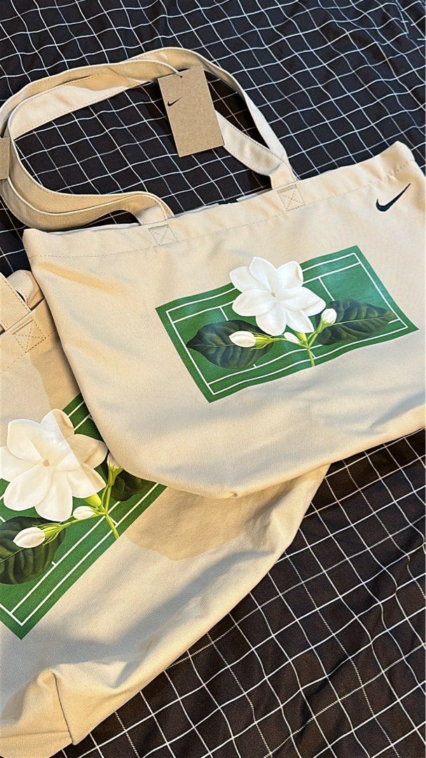 Alex Eala x Nike Tote Bag (Category: Tote Bags) located in Pasig City. Submitted by kcstuffs (Listing ID 1457108501, Image 2). Description: Nike x Alex Eala “In Full Bloom” Sampaguita Canvas Tote Bag The bag is a cream color with a black color Nike swoosh logo embroidered at the upper right corner and has her signature Sampaguita logo on the front side of the bag. Constructed from durable canvas material, suitable for daily errands or tennis gear