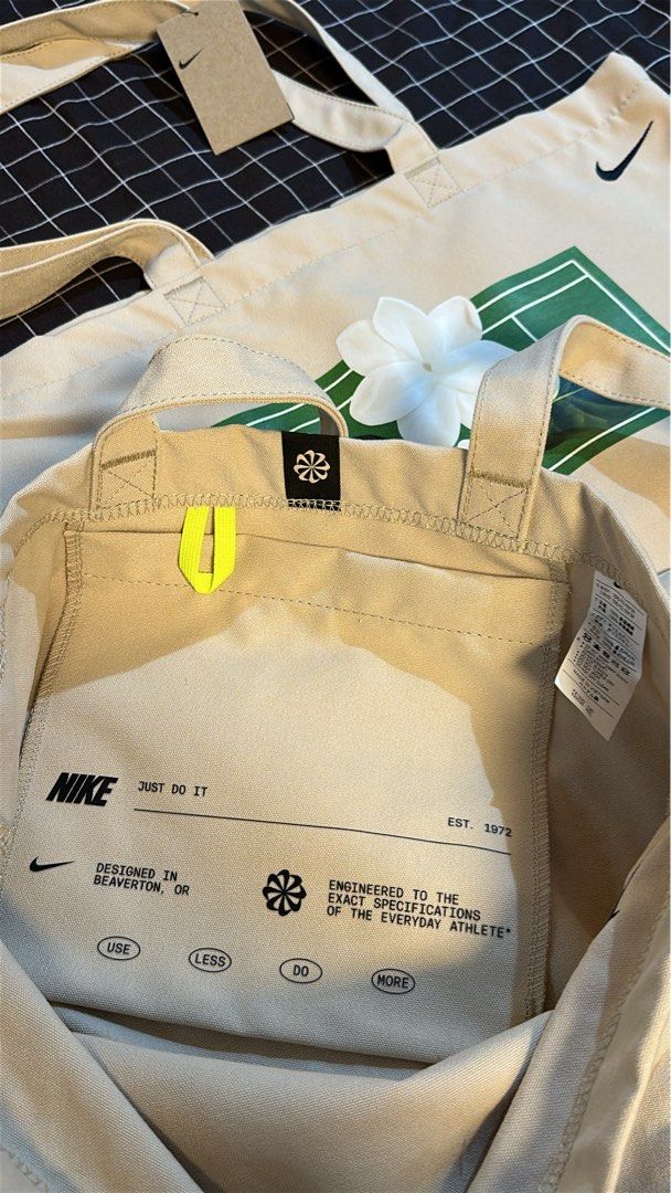 Alex Eala x Nike Tote Bag (Category: Tote Bags) located in Pasig City. Submitted by kcstuffs (Listing ID 1457108501, Image 3). Description: Nike x Alex Eala “In Full Bloom” Sampaguita Canvas Tote Bag The bag is a cream color with a black color Nike swoosh logo embroidered at the upper right corner and has her signature Sampaguita logo on the front side of the bag. Constructed from durable canvas material, suitable for daily errands or tennis gear