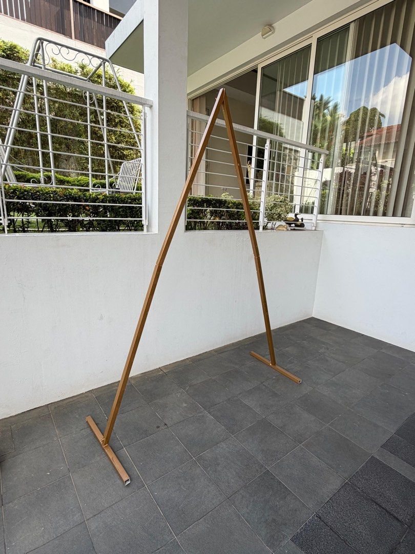 Arch Backdrop Stand Triangle (Category: Outdoor Furniture) located in Singapore. Submitted by syeow (Listing ID 1456961313, Image 2). Description: - Gold Triangle metal archway - Perfect for weddings, parties, or garden decoration - Easy to assemble - Sturdy base for stability - Can be decorated with flowers or fabric - Creates a lovely focal point - Approx. 2.5M tall x 2.1M wide.