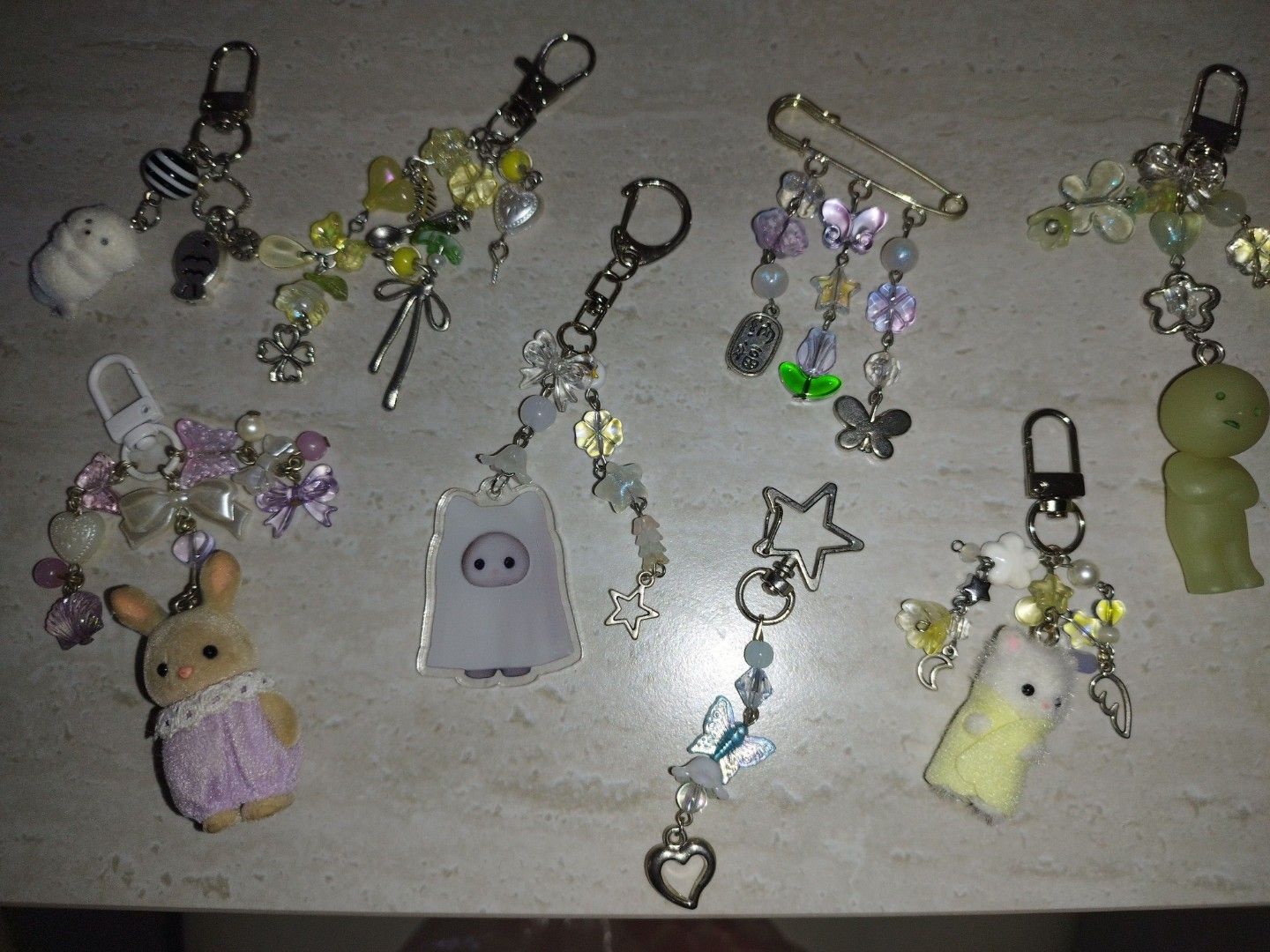 Assorted bead keychains (Category: Character Goods) located in Singapore. Submitted by unicornfarts23 (Listing ID 1457045955, Image 1). Description: DM for condi! buy more for cheaper yellow beaded keychain ❌ blue beaded keychain $2 purple slyvanian keychain $9 ghost slyvanian acrylic keychain beaded $6 smiski beaded keychain $11 yellow mini slyvanian beaded keychain $12 purple pin beaded ❌ Take rest for $32!! .