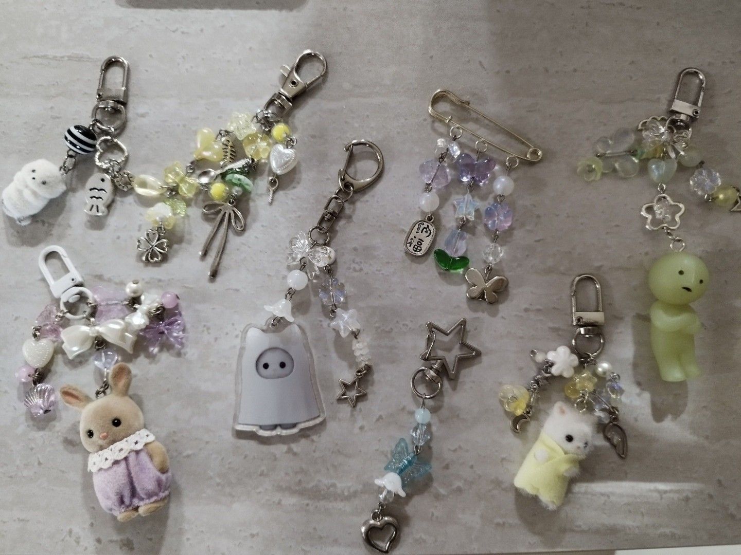Assorted bead keychains (Category: Character Goods) located in Singapore. Submitted by unicornfarts23 (Listing ID 1457045955, Image 3). Description: DM for condi! buy more for cheaper yellow beaded keychain ❌ blue beaded keychain $2 purple slyvanian keychain $9 ghost slyvanian acrylic keychain beaded $6 smiski beaded keychain $11 yellow mini slyvanian beaded keychain $12 purple pin beaded ❌ Take rest for $32!! .