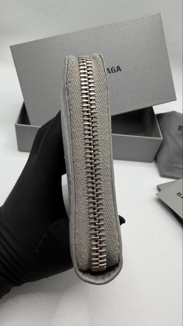 Balenciaga Grey Leather Zip Around Wallet (Category: Luxury Bags & Wallets) located in Pasig City. Submitted by shoptilyoudrop87 (Listing ID 1457133232, Image 3). Description: - Authentic Balenciaga zip around wallet - Color: Grey leather - Features classic Balenciaga logo on the front - Includes original box, dust bag, and authenticity card -Barely noticeable transfer stain as seen in the photo - Ample space for cards and cash - Ideal for everyd