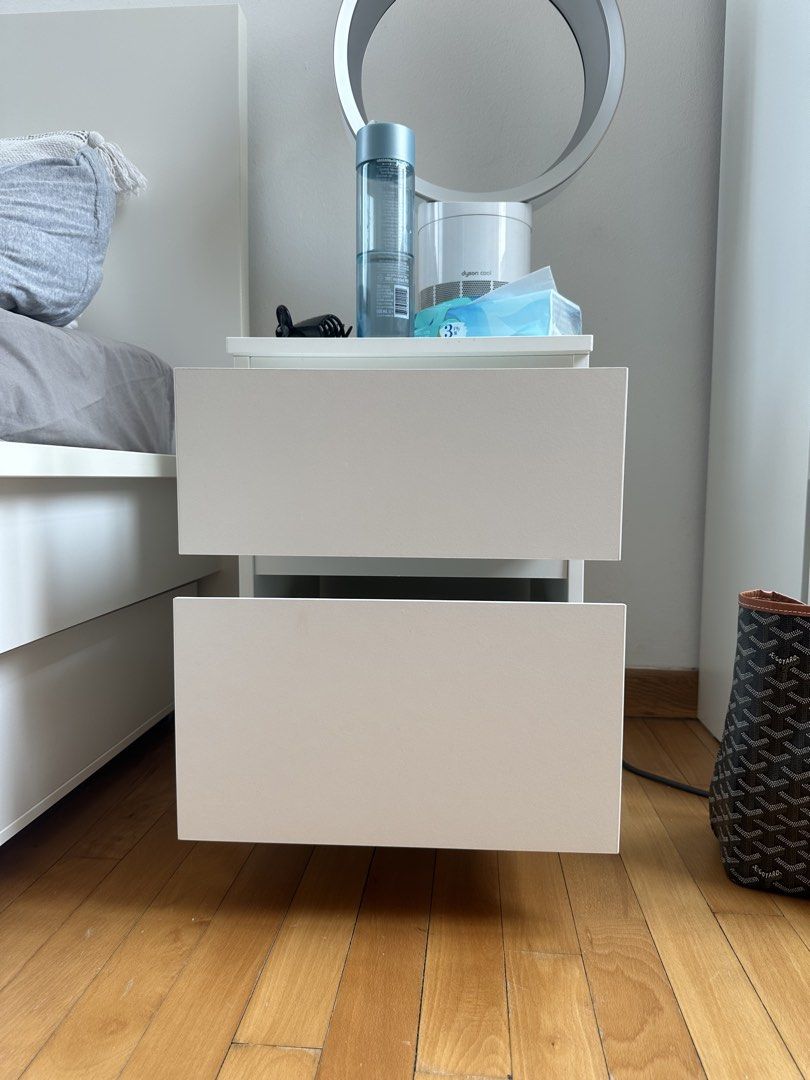 Bed Side Table (Category: Tables & Sets) located in Singapore. Submitted by lealouye (Listing ID 1457001385, Image 2). Description: White bedside table with two drawers. Modern and minimalist design. The inside of the upper drawer is slightly yellowed, but this may be removable with a Cif cleaning product..