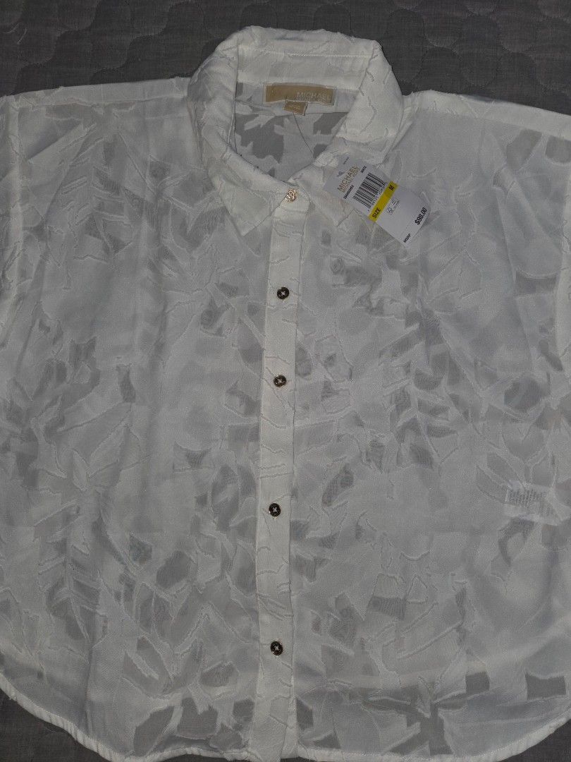 BNWT Michael Kors White Sheer Leaf Pattern Button-Up Shirt Size M (Category: Shirts) located in Manila. Submitted by eveeven (Listing ID 1457027816, Image 2). Description: - Brand: BNWT Michael Kors 100% original - Color: White - Material: Sheer fabric - Pattern: Subtle all-over leaf pattern - Sleeves: Short sleeves - Closure: Button-up front - Condition: Brand new with original tags attached - Size: Medium - Styling: Perfect for layering or wear