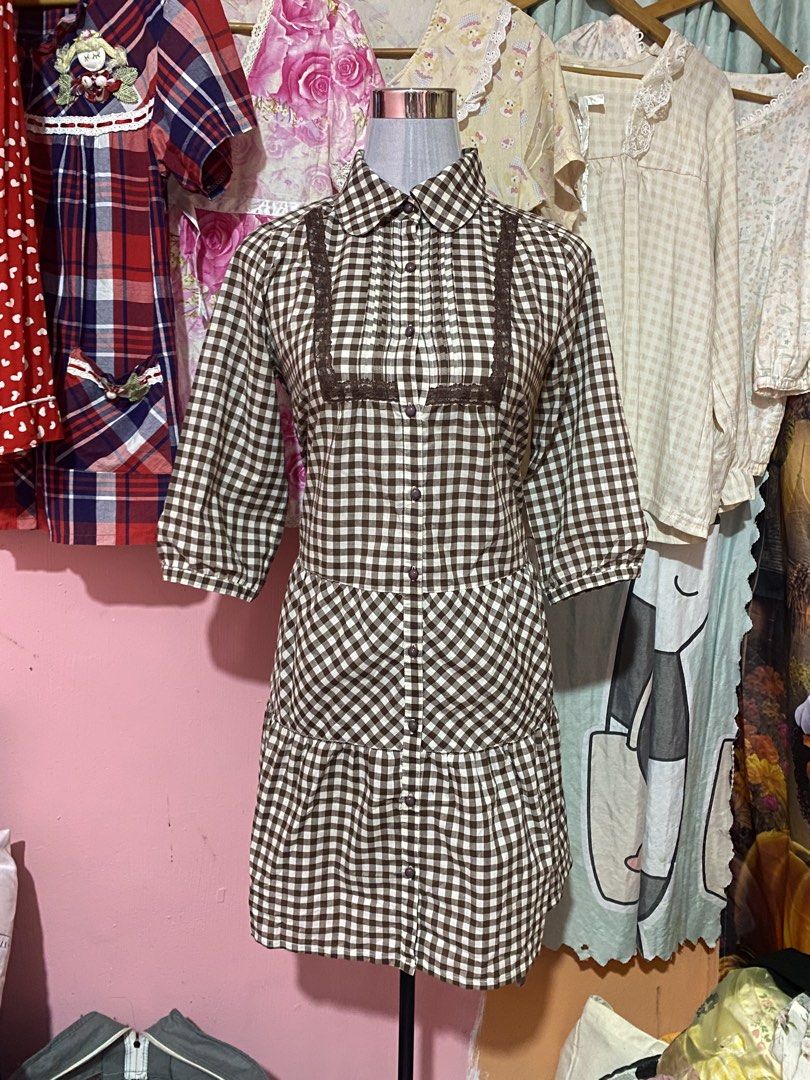 Brown Gingham Checkered Dress with Lace Trim (Category: Dresses) located in Urdaneta. Submitted by mikaychiii (Listing ID 1457131452, Image 1). Description: - Adorable brown and white checkered pattern - Classic Peter Pan collar with delicate lace trim - Button-up front for easy wear - Stylish 3/4 length sleeves - Flirty tiered, ruffled hem skirt - Ideal for casual days, picnics, and everyday charm.