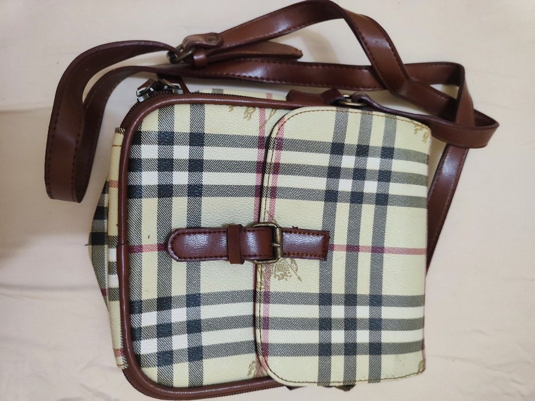 Burberry Nova Check Crossbody Bag (Category: Luxury Bags & Wallets) located in Paniqui. Submitted by arlenepari29210 (Listing ID 1457116879, Image 1). Description: - Classic Burberry crossbody bag - Iconic Nova Check pattern - Genuine leather trim and strap - Secure buckle closure on flap - Internal zipped compartments for storage - Perfect for everyday use - Shows some signs of wear, but plenty of life left - Authenticity not guarantee, ukay sou