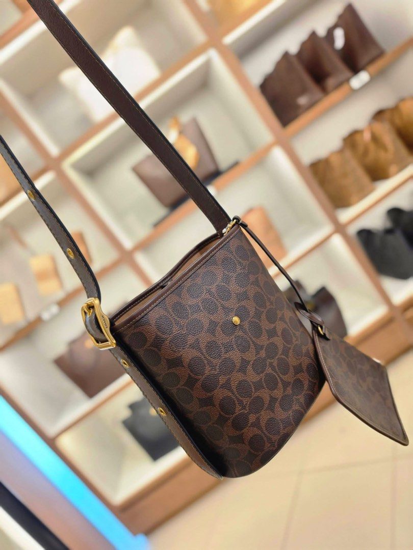 Coach Bleeker 21 bucket bag (Category: Luxury Bags & Wallets) located in Santa Rosa. Submitted by megally (Listing ID 1457077108, Image 3). Description: - Authentic brown Coach shoulder bag - Classic monogram print - Comes with a matching small pouch - Elegant gold hardware details - Adjustable strap for comfort - Ideal for everyday style and practicality Pinas On-hand Coach Bleeker 21 Original Send PM to inquire .