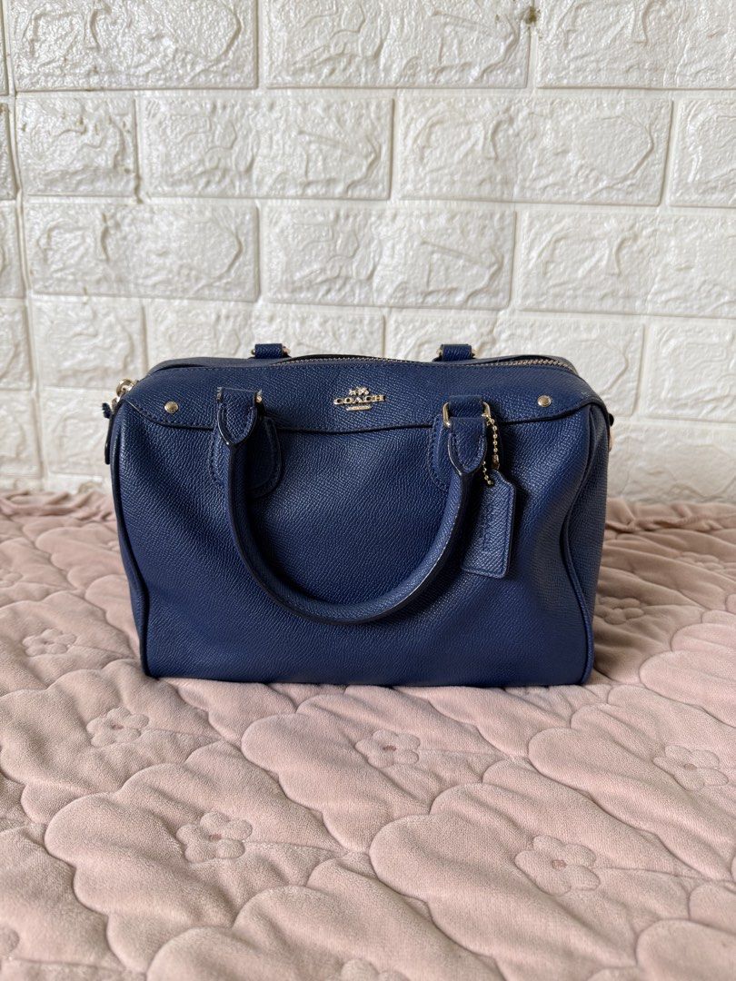 Coach Navy Blue Leather Satchel Bag (Category: Luxury Bags & Wallets) located in Santa Maria. Submitted by farmerjohnswife (Listing ID 1456959361, Image 1). Description: - Authentic Coach satchel bag in navy blue. - Crafted from durable pebbled leather. - Elegant gold hardware details. - Versatile carrying options: top handles and detachable shoulder strap. - Spacious interior to hold your daily essentials. - no inclusion.