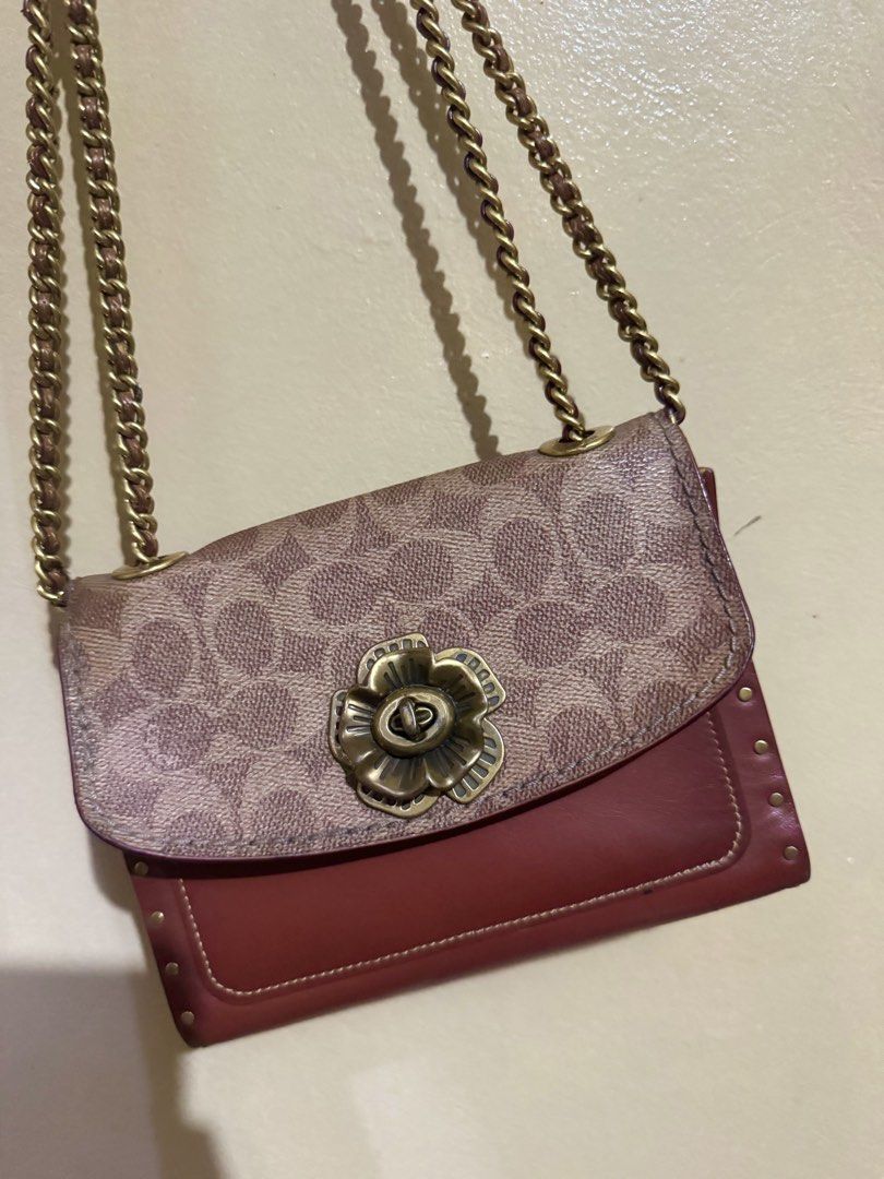 Coach Parker 18 Signature Canvas Rust (Category: Luxury Bags & Wallets) located in Santa Rosa. Submitted by justdecluterring_ (Listing ID 1457058481, Image 1). Description: - Authentic Coach Parker 18 bag - Signature coated canvas with rust-red leather base - Tea rose turnlock closure - Gold chain strap and stud details -Made in Philippines -Minimal issue.