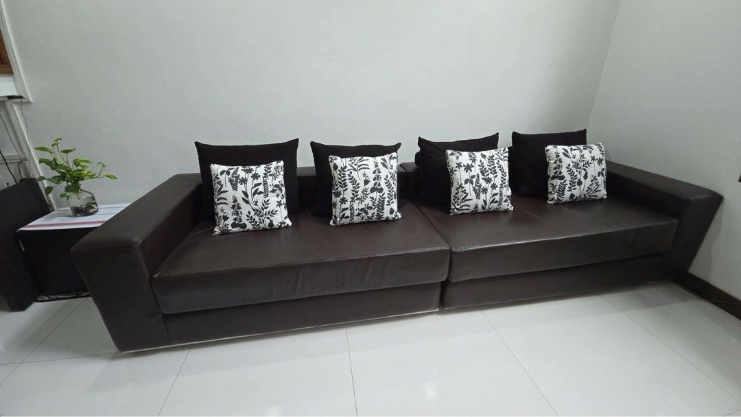 Dark Brown Leather L-Shaped Sofa with Cushions (Category: Sofas) located in Pasig City. Submitted by jvcanzon (Listing ID 1457104097, Image 3). Description: - Dark brown leather L-shaped sofa - Includes black and floral print cushions - Comfortably seats multiple people - Perfect for living rooms or lounges - Pick up only Size: Depth - 114cm Width - 320cm Height - 65cm Brand New price: 90k.