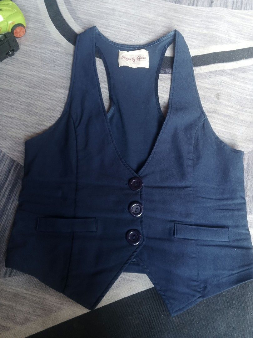 Design by Olivia Blue Sleeveless Button-Up Vest (Category: Announcements) located in Manila. Submitted by icamalicdem29 (Listing ID 1457020910, Image 2). Description: - Blue sleeveless vest by Design by Olivia - Button-up front - Two pocket details - Adjustable strap at the back with gold buckle - Racerback style - Ideal for layering over tops or dresses - Made in Vietnam.