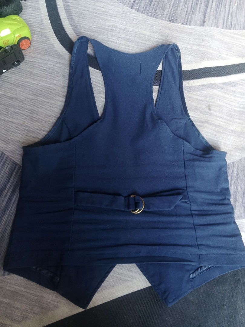 Design by Olivia Blue Sleeveless Button-Up Vest (Category: Announcements) located in Manila. Submitted by icamalicdem29 (Listing ID 1457020910, Image 3). Description: - Blue sleeveless vest by Design by Olivia - Button-up front - Two pocket details - Adjustable strap at the back with gold buckle - Racerback style - Ideal for layering over tops or dresses - Made in Vietnam.