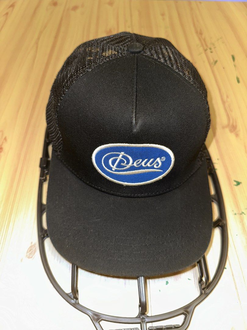 Deus Ex Machina Black Mesh Sparks Trucker Cap (Category: Caps & Hats) located in Quezon City. Submitted by mancave_stuff (Listing ID 1456966404, Image 1). Description: - Brand: Deus Ex Machina - Style: Trucker Cap - Features: Mesh back for breathability - Logo: Classic Deus oval logo on front - Embroidery: 'Deus Ex Machina' on back - Closure: Adjustable snapback - Ideal for: Casual wear -Used once only.