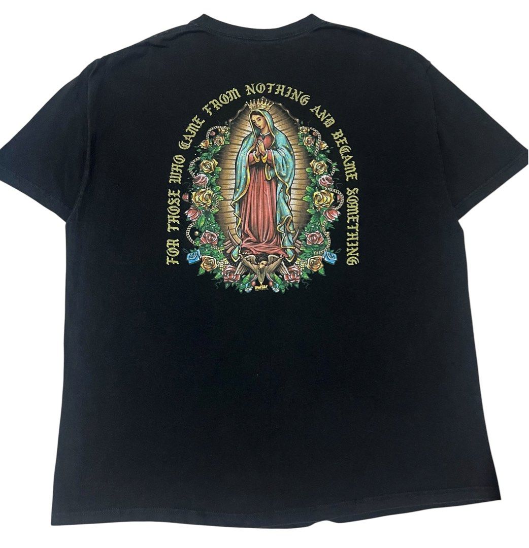 DGK "Guadalupe" T-Shirt (Category: Tshirts & Polo Shirts ) located in Manila. Submitted by rhaldstsh.ph (Listing ID 1457110177, Image 2). Description: This black graphic tee is one of DGK’s most iconic and culturally significant designs, representing themes of perseverance and hustle. Front Graphic: Features a subtle chest logo showcasing a beautifully illustrated pink rose centered beneath a gold gothic-style DGK spell-out. Back Graphic: A massi