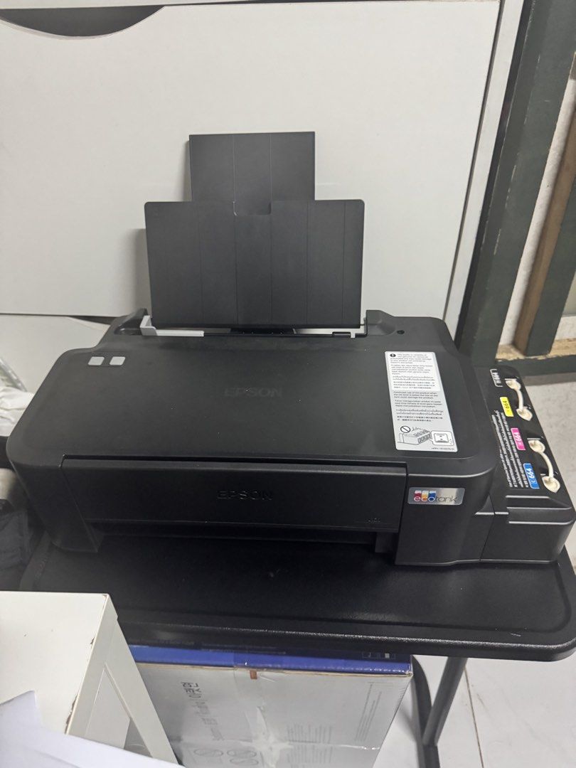 Epson Ecotank printer w/ ink cartridge (Category: Printers, Scanners & Copiers) located in Quezon City. Submitted by mateyyy_ (Listing ID 1457019633, Image 2). Description: Epson L121 Ecotank Printer w/ complete ink cartridge RFS: rarely used.
