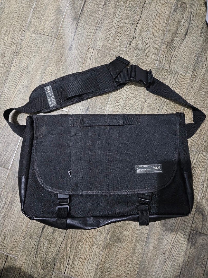 Everlast Tactical / Utility Messenger Bag (Category: Laptop Bags & Sleeves) located in Pasay City. Submitted by pass.it.on.ph (Listing ID 1457130477, Image 1). Description: Brand: Everlast ("Greatness Is Within") ​Style: Crossbody Messenger Bag / Laptop Shoulder Bag ​Color: All Black (Durable Polyester Canvas with synthetic/faux-leather trim) ​Tag Details: Made in China for the Korean market (Manufactured January 2019) ​Features: ​Dual buckle fla