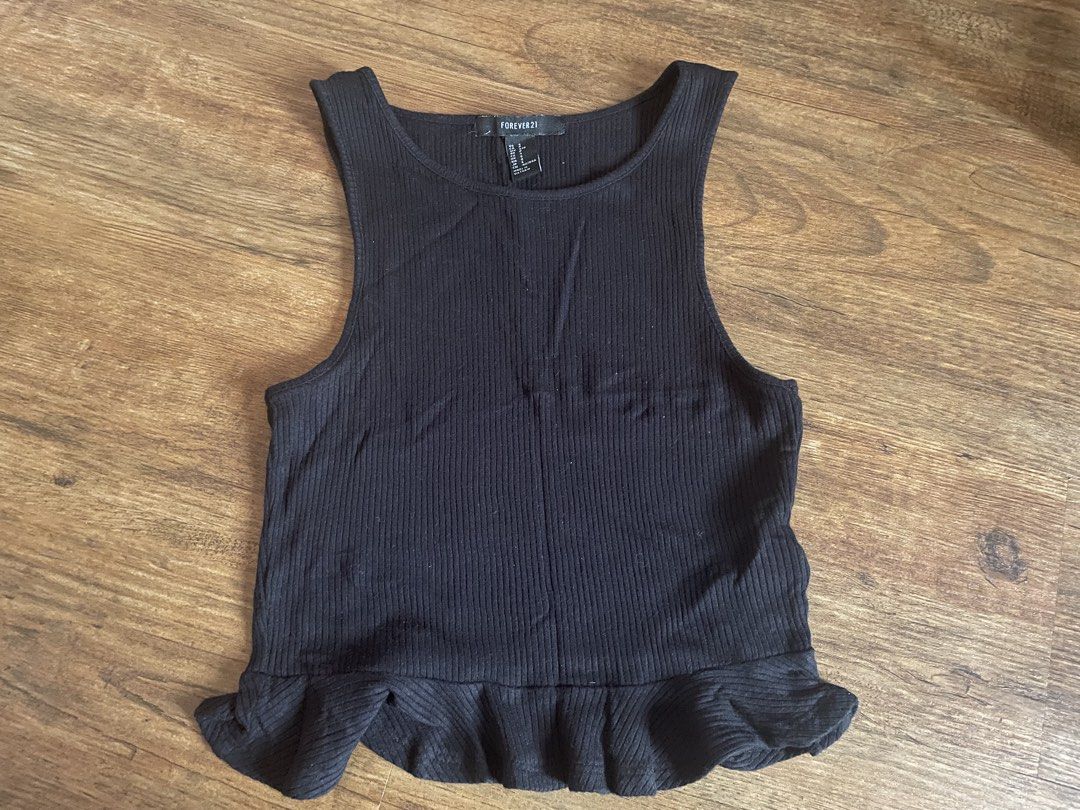 Forever 21 Black Ribbed Peplum Tank Top (Category: Sleeveless) located in Mexico. Submitted by nextowner.zip (Listing ID 1456962082, Image 1). Description: - Forever 21 black ribbed tank top - Features a flattering peplum hem - Sleeveless design - Perfect for layering or wearing on its own - Easily pairs with jeans or skirts.
