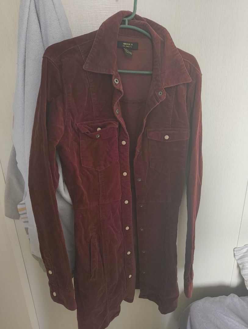 Forever 21 Corduroy Button-Up Shirt (Category: Shirts) located in Makati City. Submitted by macegray (Listing ID 1457034342, Image 1). Description: - Maroon corduroy shirt - Brand: Forever 21 - Long sleeves with button cuffs - Two chest pockets with button closures - Button-up front - Versatile: perfect for layering or wearing on its own.