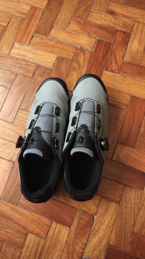 Grey Cycling Shoes with BOA Dial Closure (Category: Sneakers) located in Tarlac. Submitted by limidoloy191416 (Listing ID 1456968815, Image 1). Description: - Grey cycling shoes - Features a BOA dial closure system for a secure and precise fit - Soles are equipped with cleats for clipless pedals - Offers good grip on the bottom for stability - Perfect for your next cycling adventure.